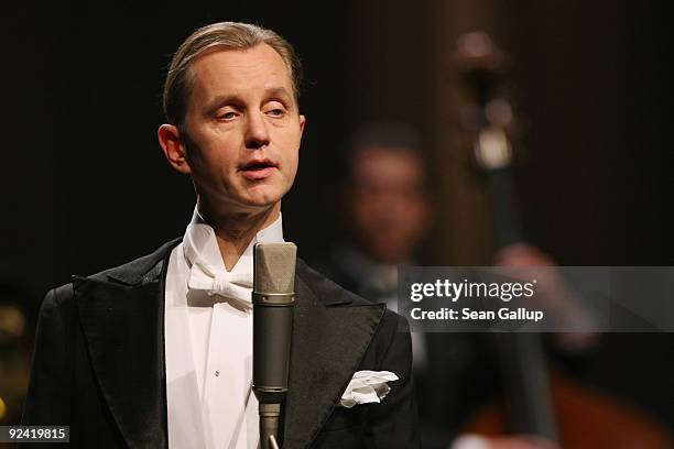 German singer Max Raabe performs with his Palast Orchester orchestra at a photocall for the release of his new DVD "Heute Nacht Oder Nie" at...