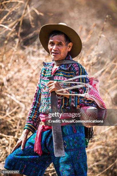 mayan man walking with bag, looking at camera. - lake atitlan stock pictures, royalty-free photos & images