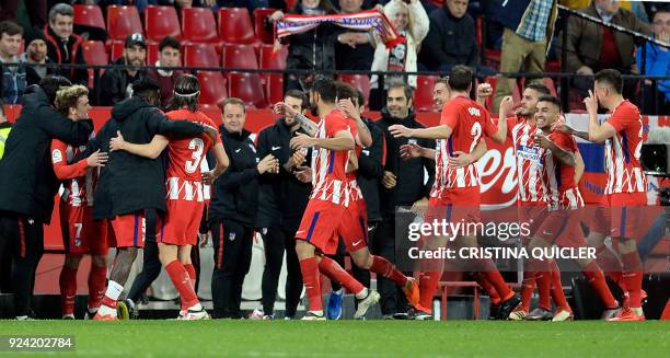 Atletico Madrid's players celebrate after French forward Antoine Griezmann scored a goal during the Spanish league football match between Sevilla FC...