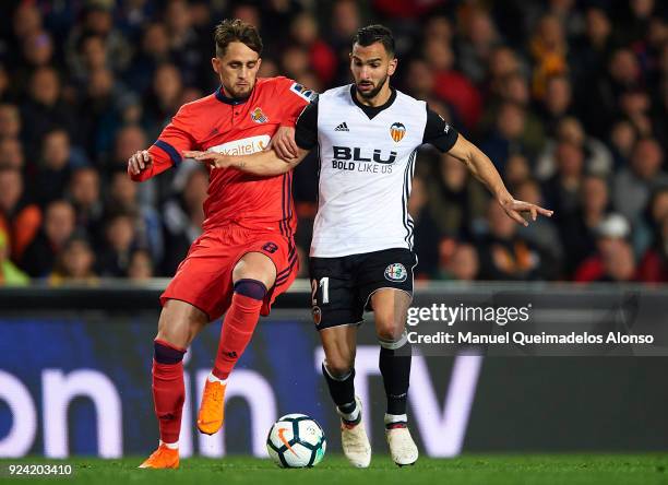 Martin Montoya of Valencia competes for the ball with Adnan Januzaj of Real Sociedad during the La Liga match between Valencia CF and Real Sociedad...