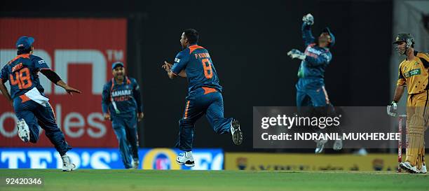 Indian cricketers led by bowler Praveen Kumar celebrate the wicket of Australian batsman Ricky Ponting during the second One Day International match...