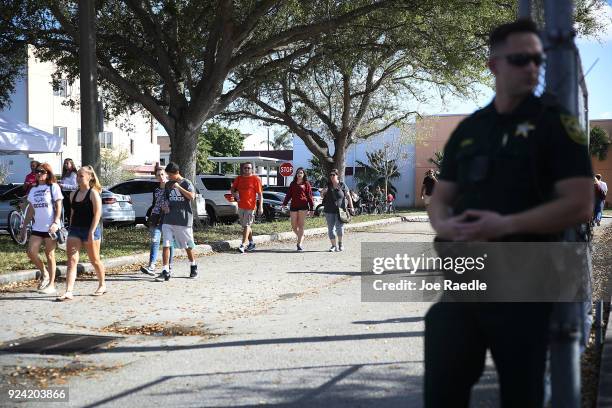 People visit Marjory Stoneman Douglas High School on February 25, 2018 in Parkland, Florida. Today, students and parents were allowed on campus for...