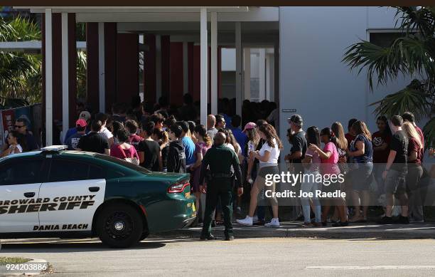 People visit Marjory Stoneman Douglas High School on February 25, 2018 in Parkland, Florida. Today, students and parents were allowed on campus for...