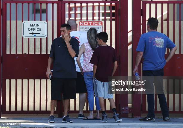 People use the main entrance to Marjory Stoneman Douglas High School on February 25, 2018 in Parkland, Florida. Today, students and parents were...