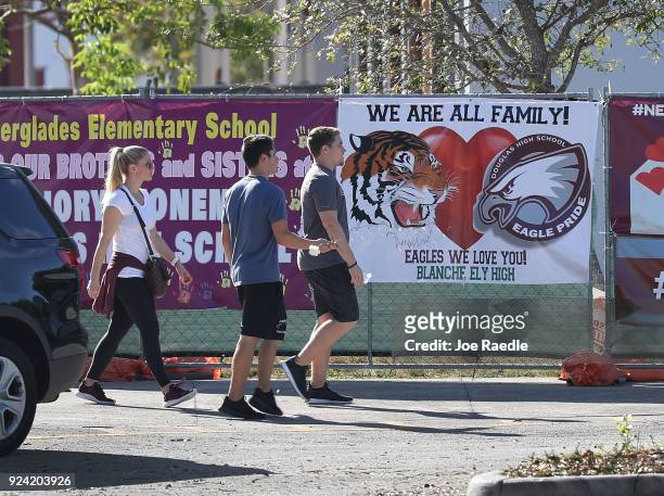 People are seen in front of the freshman building where the mass shooting took place at Marjory Stoneman Douglas High School on February 25, 2018 in...