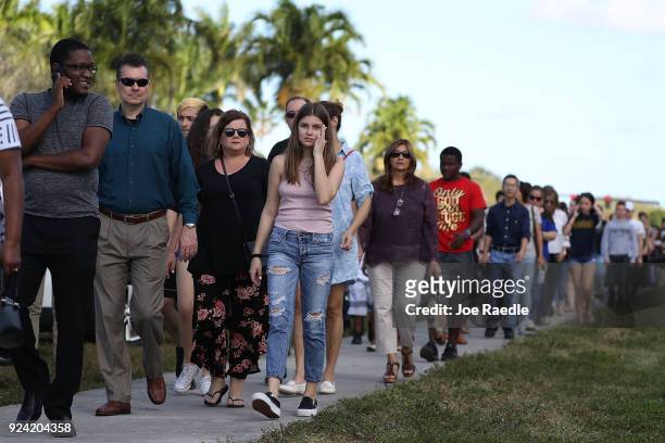 People wait in line to visit Marjory Stoneman Douglas High School on February 25, 2018 in Parkland, Florida. Today, students and parents were allowed...