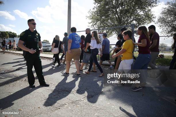 People visit Marjory Stoneman Douglas High School on February 25, 2018 in Parkland, Florida. Today, students and parents were allowed on campus for...