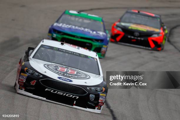 Kevin Harvick, driver of the Jimmy John's Ford, leads Ryan Newman, driver of the Liberty National Chevrolet, and Martin Truex Jr., driver of the Bass...