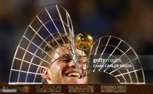 Argentina's Diego Schwartzman celebrates with the trophy after beating Spain's Fernando Verdasco during their ATP World Tour Rio Open singles final...