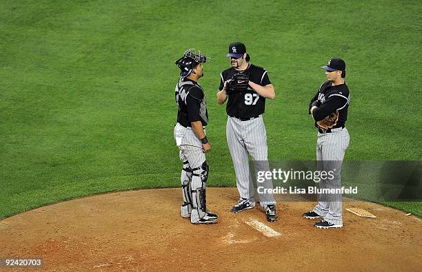 Yorvit Torrealba, Joe Biemel and Troy Tulowitzki of the Colorado Rockies meet on the mound during the game against the Los Angeles Dodgers at Dodger...