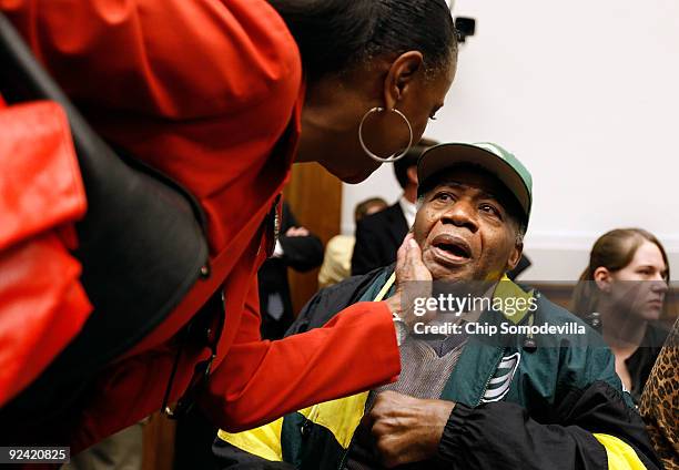 Sylvia Mackey , wife of former National Football Player John Mackey, greets Pro Football Hall of Fame player Willie Woods before a hearing of the...