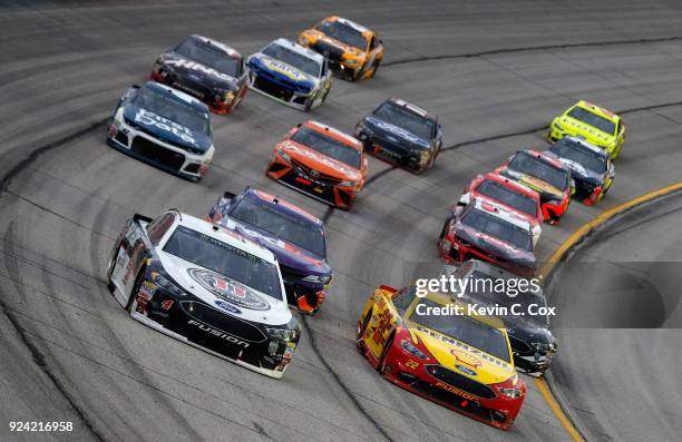 Kevin Harvick, driver of the Jimmy John's Ford, and Joey Logano, driver of the Shell Pennzoil Ford, lead a pack of cars during the Monster Energy...