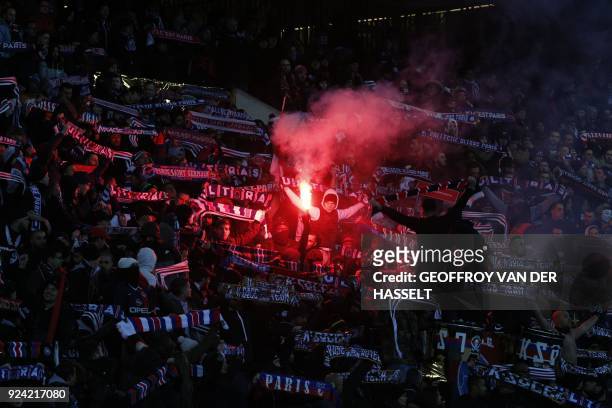 Paris Saint-Germain's supporters cheer with flares and flags during the French L1 football match between Paris Saint-Germain and Marseille at the...