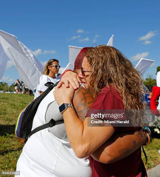 Pulse survivor India Godman, left, hugs Wendy Garrity at Marjory Stoneman Douglas High School on Sunday, February 25 during an open house as parents...