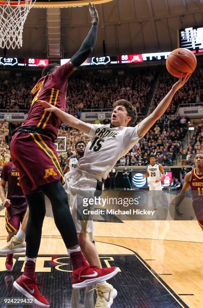 Tommy Luce of the Purdue Boilermakers shoots the ball against Gaston Diedhiou of the Minnesota Golden Gophers at Mackey Arena on February 25, 2018 in...
