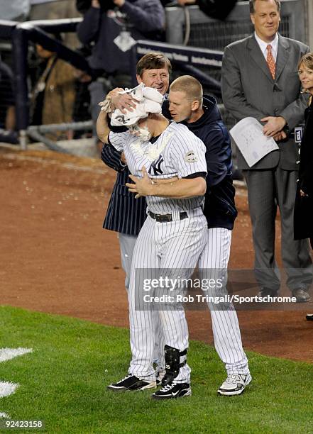 Mark Teixeira of the New York Yankees gets a pie in the face by teammate A.J. Burnett after hitting a walk off home run in the eleventh inning...