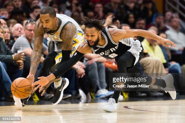 Smith of the Cleveland Cavaliers and Patty Mills of the San Antonio Spurs dive for a loose ball during the second half at Quicken Loans Arena on...