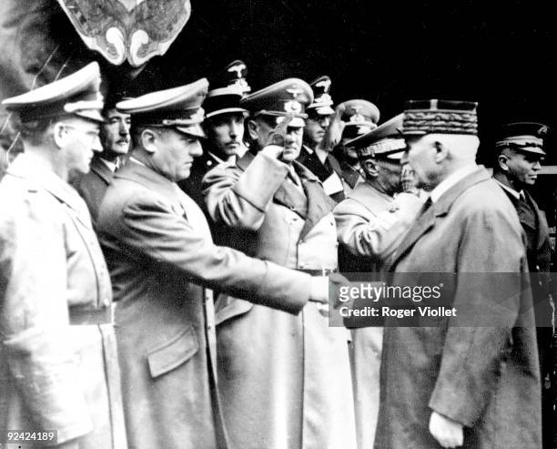 World War II. Marshal Philippe Pétain shaking hands with German ambassador Otto Abetz, during General Charles Huntziger's national funeral, in Vichy,...