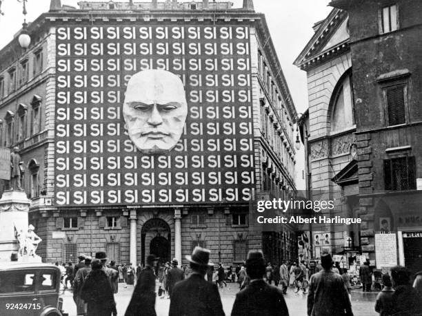 World War II. Mask of Mussolini on the facade of a building.