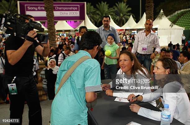Liezel Huber of the USA and Cara Black of Zimbabwe sign autographs for fans during the Sony Ericsson Championships at the Khalifa Tennis and Squash...