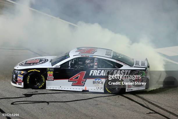 Kevin Harvick, driver of the Jimmy John's Ford, celebrates with a burnout after winning the Monster Energy NASCAR Cup Series Folds of Honor QuikTrip...