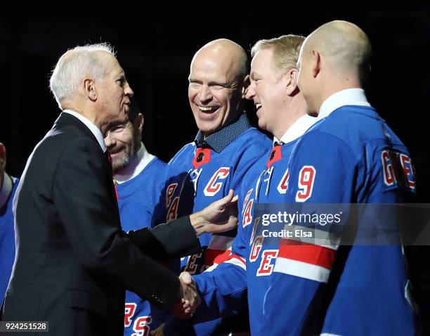 Former New York Rangers Jean Ratelle speaks with former players Mark Messier, Brian Leetch and Adam Graves before Ratelle's jersey retirement...