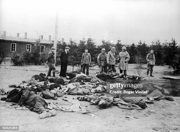 World War II. Americans and survivors looking at the last victims of the Ohrdruf concentration camp .