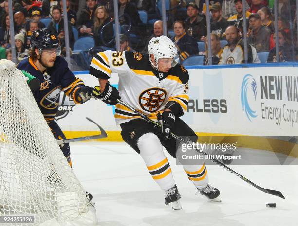 Brad Marchand of the Boston Bruins carries the puck against Nathan Beaulieu of the Buffalo Sabres during an NHL game on February 25, 2018 at KeyBank...