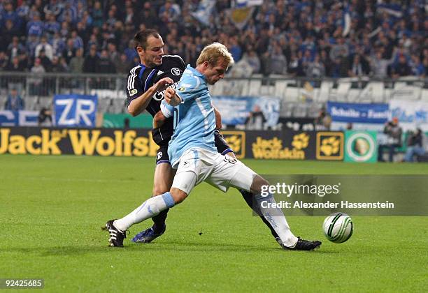 Stefan Aigner of Muenchen battles for the ball with Heiko Westermann of Schalke during the DFB Cup round of 16 match between 1860 Muenchen and FC...