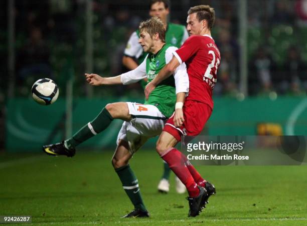 Aaron Hunt of Bremen and Daniel Pavlovic of Kaiserslautern battle for the ball during the DFB Cup round of 16 match between between Werder Bremen and...
