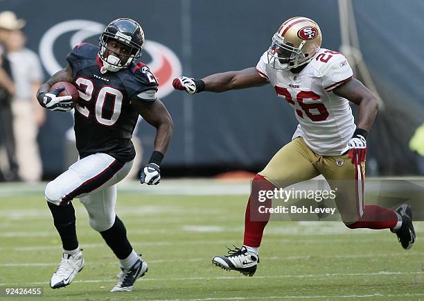 Running back Steve Slaton of the Houston Texans avoids a tackle by safety Mark Roman of the San Francisco 49ers at Reliant Stadium on October 25,...