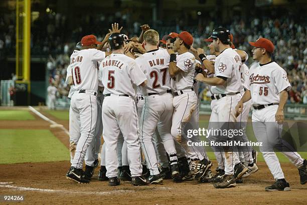 The Houston Astros greet catcher Greg Zaun at home plate after his game-winning ninth inning grand slam during the MLB game against the Arizona...