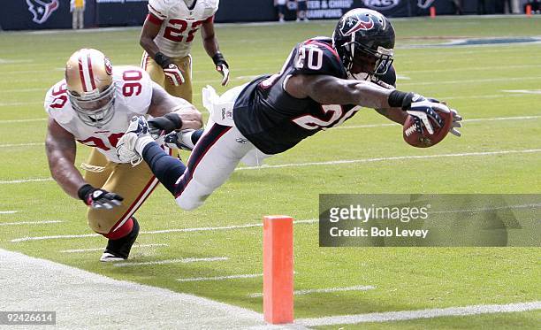 Running back Steve Slaton of the Houston Texans avoids a tackle by defensive tackle Isaac Sopoaga of the San Francisco 49ers as he dives for the...