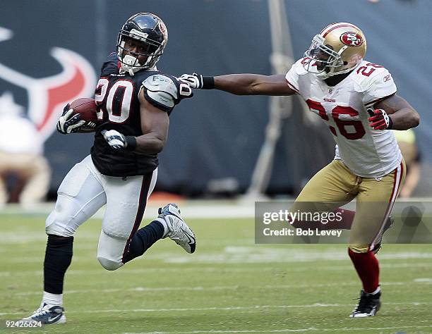 Running back Steve Slaton of the Houston Texans avoids a tackle by safety Mark Roman of the San Francisco 49ers at Reliant Stadium on October 25,...