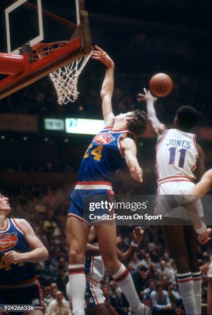 Bobby Jones of the Denver Nuggets battles for a rebound with Caldwell Jones of the Philadelphia 76ers during an NBA basketball game circa 1977 at The...