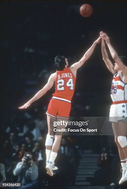 Mitch Kupchak of the Washington Bullets shoots over Bobby Jones of the Philadelphia 76ers during an NBA basketball game circa 1981 at the Capital...