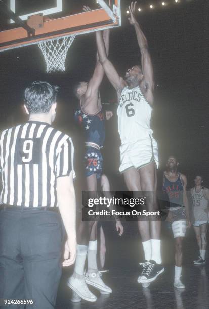 Bill Russell of the Boston Celtics shoots over Wilt Chamberlain of the Philadelphia 76ers during an NBA basketball game circa 1965 at the Boston...