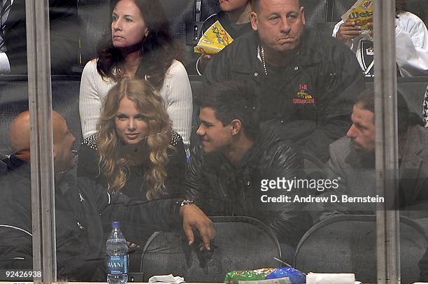 Taylor Lautner and Taylor Swift attend the NHL game between the Columbus Blue Jackets and the Los Angeles Kings during the game on October 25, 2009...