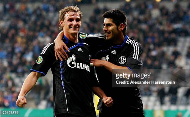 Benedikt Hoewedes of Schalke celebrates after scoring his team's third goal with his team mate Carlos Zambrano during the DFB Cup round of 16 match...