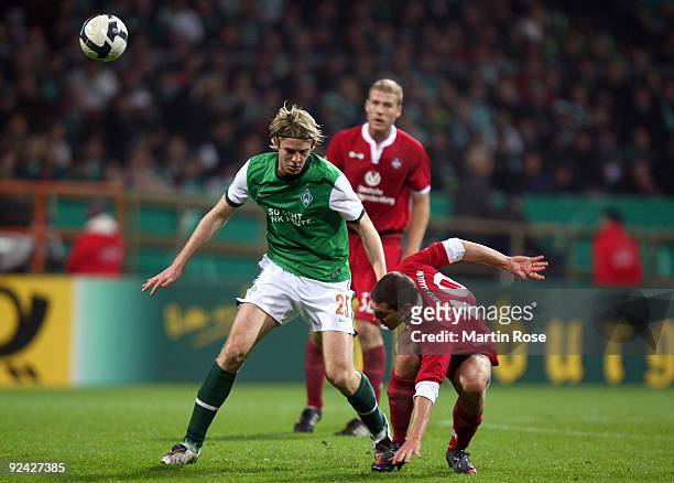 Peter Niemeyer of Bremen and Jiri Bilek of Kaiserslautern compete for the ball during the DFB Cup round of 16 match between between Werder Bremen and...