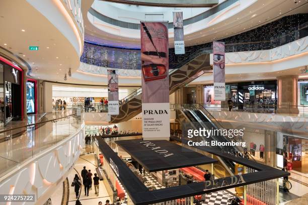 Visitors walk through the Promenade Shops shopping area of the Galaxy Macau casino and hotel, developed by Galaxy Entertainment Group Ltd., in Macau,...