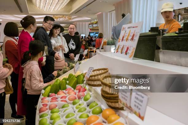 Tourists order at a food court in the Promenade Shops shopping area of the Galaxy Macau casino and hotel, developed by Galaxy Entertainment Group...