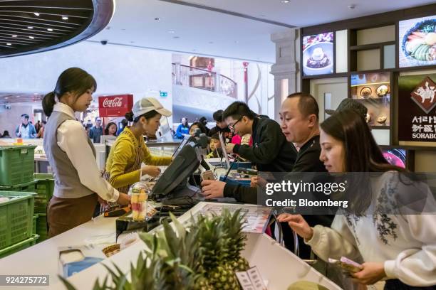 Juice BarEmployees take customers' orders at a food court in the Promenade Shops shopping area of the Galaxy Macau casino and hotel, developed by...