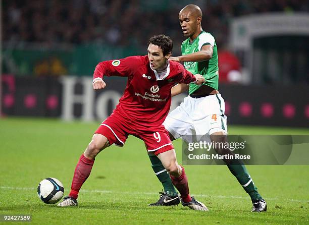 Naldo of Bremen and Srdjan Lakic of Kaiserslautern compete for the ball during the DFB Cup round of 16 match between between Werder Bremen and 1. FC...