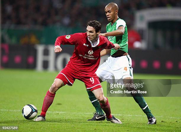 Naldo of Bremen and Srdjan Lakic of Kaiserslautern compete for the ball during the DFB Cup round of 16 match between between Werder Bremen and 1. FC...