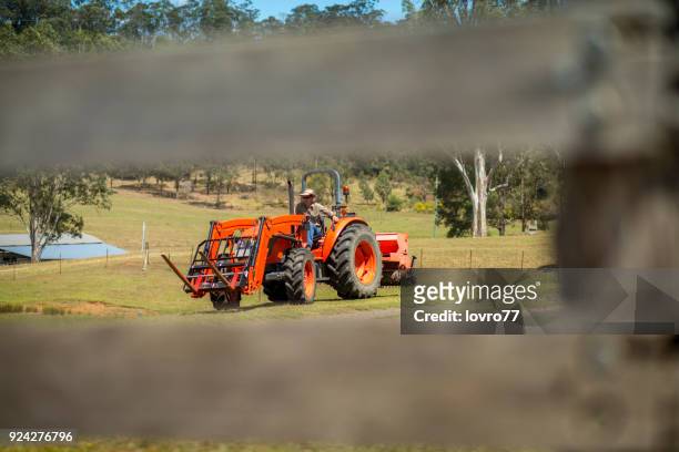 el agricultor cultiva su granja con un tractor - farm australia combine fotografías e imágenes de stock