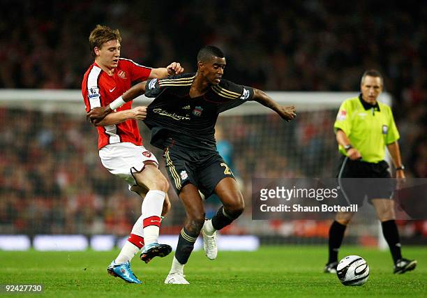 Damien Plessis of Liverpool is challenged by Nicklas Bendtner of Arsenal during the Carling Cup 4th Round match between Arsenal and Liverpool at the...