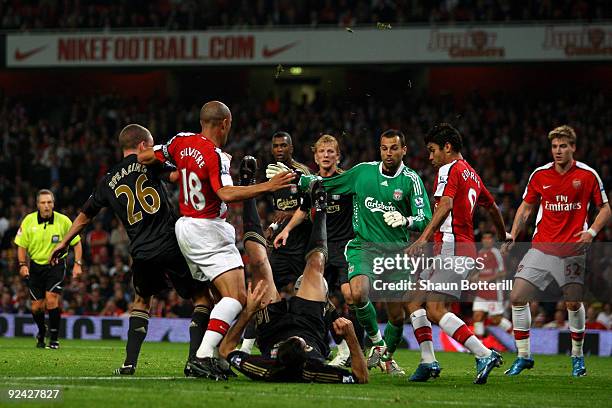 Jay Spearing, Sotirios Kyrgiakos and Diego Cavalieri of Liverpool tussle with Mikael Silvestre and Eduardo of Arsenal during the Carling Cup 4th...