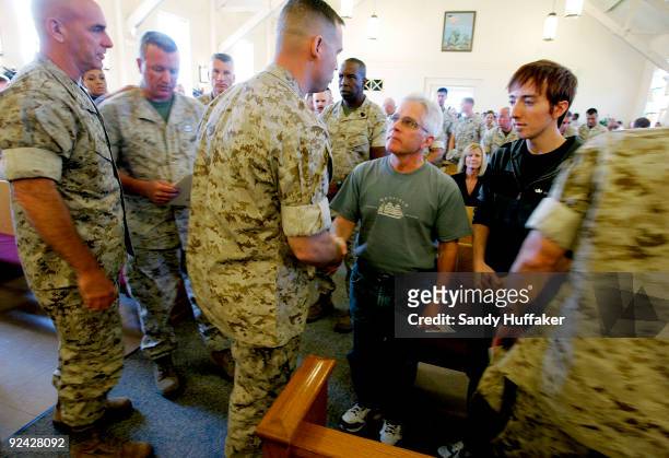 Marines pay their respects to Clifford Taylor during a memorial service for his son, Staff Sgt. Aaron J. Taylor in the Chapel at Camp Pendleton on...