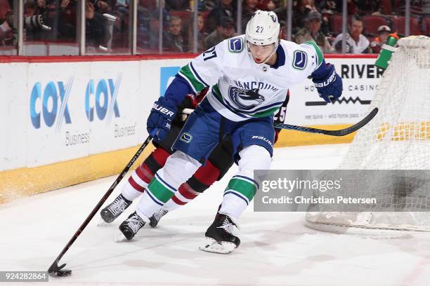 Ben Hutton of the Vancouver Canucks skates with the puck during the first period of the NHL game against the Arizona Coyotes at Gila River Arena on...